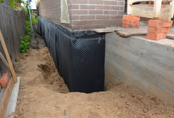 SJ Waterproofing Pros technician performing targeted Wet Basement Repair assessment in Randolph, AL